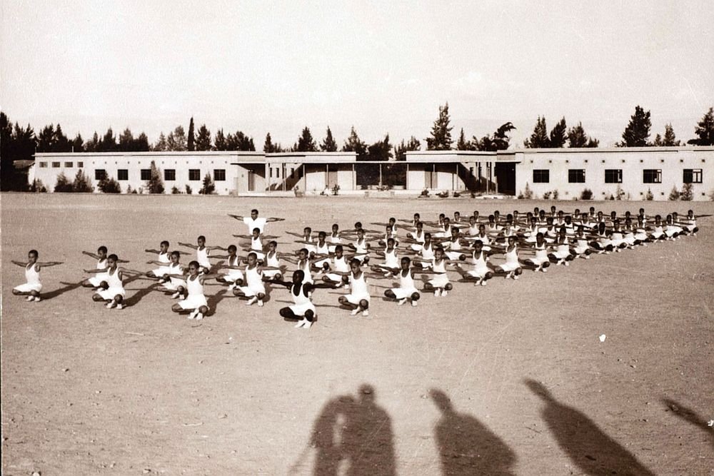 Students at the Arab Development Society are photographed carrying out their physical education exercises, 1950s.